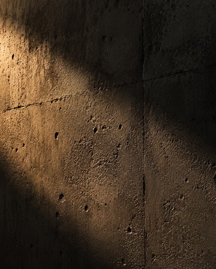 Raw concrete surface in warm raking light
